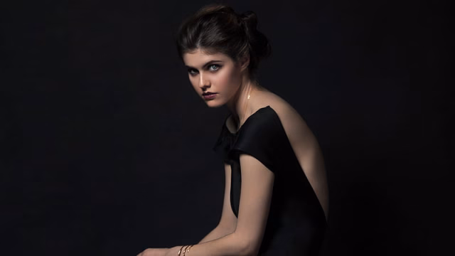 HD-wallpaper-alexandra-daddario-is-wearing-black-dress-in-a-black-background-facing-one-side-celebrities