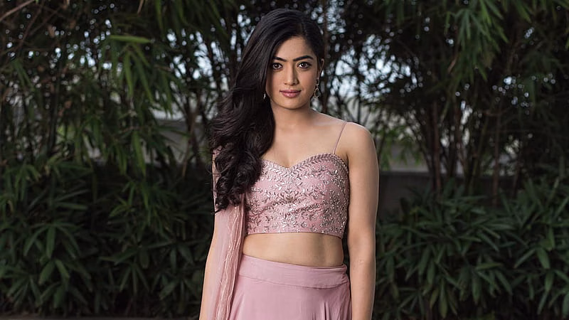 HD-wallpaper-beautiful-rashmika-mandanna-is-wearing-peach-color-dress-standing-in-green-trees-background-girls