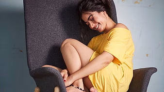 HD-wallpaper-nice-smiley-rashmika-mandanna-is-sitting-on-couch-wearing-yellow-dress-girls-thumbnail