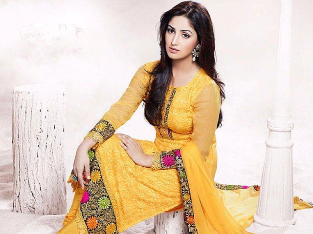 HD-wallpaper-yami-gautam-indian-actress-dark-hair-sleeves-embroidery-earrings-dress-in-mustard-colour-column-posing-on-chair