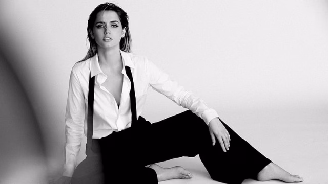 HD-wallpaper-ana-de-armas-is-sitting-on-the-floor-and-wearing-white-shirt-and-black-pant-with-shoulder-belt-celebrities